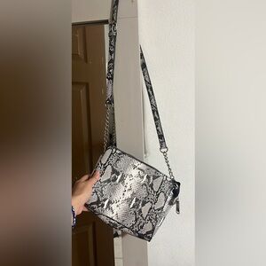 Snake print cross body purse.